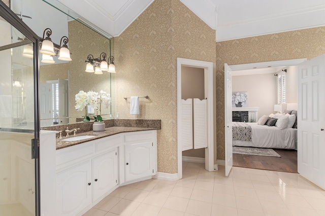 bathroom featuring tile patterned flooring, vanity, and crown molding