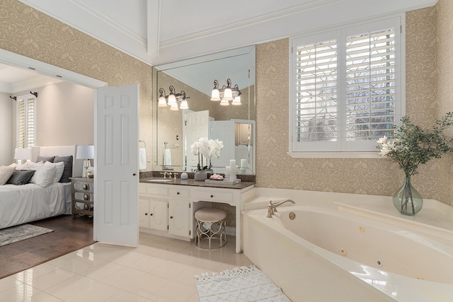 bathroom featuring tile patterned flooring, vanity, crown molding, and a tub