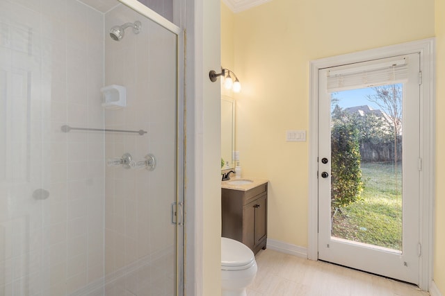 bathroom with vanity, toilet, and an enclosed shower