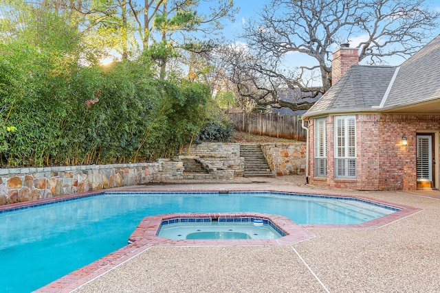 view of pool featuring an in ground hot tub