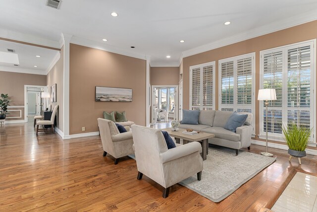 living room featuring light hardwood / wood-style flooring and ornamental molding