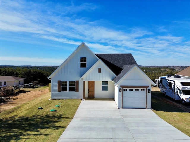 modern farmhouse style home with a front yard and a garage