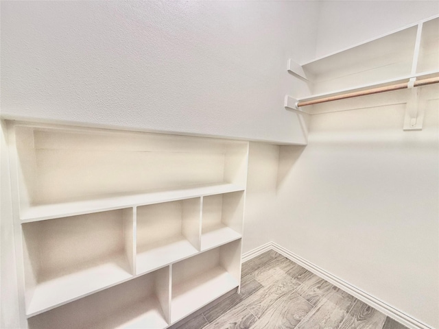 spacious closet featuring hardwood / wood-style floors