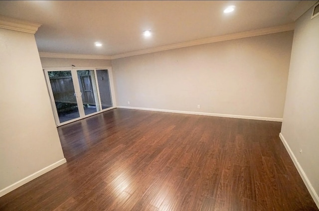 spare room with dark hardwood / wood-style floors and ornamental molding