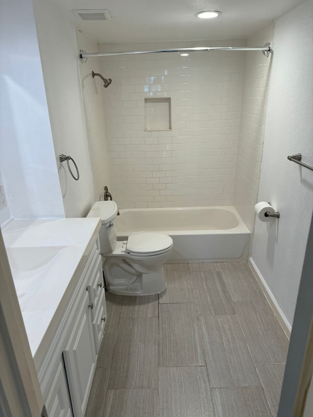 full bathroom with vanity, toilet, and tiled shower / bath combo