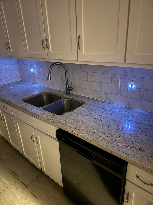 kitchen with tasteful backsplash, dishwasher, white cabinets, and sink