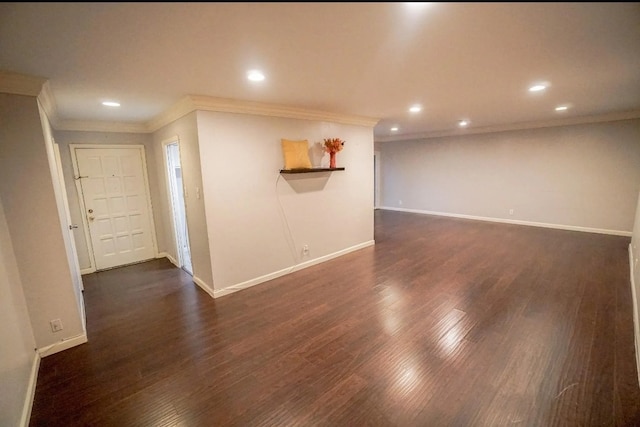 unfurnished room featuring ornamental molding and dark wood-type flooring