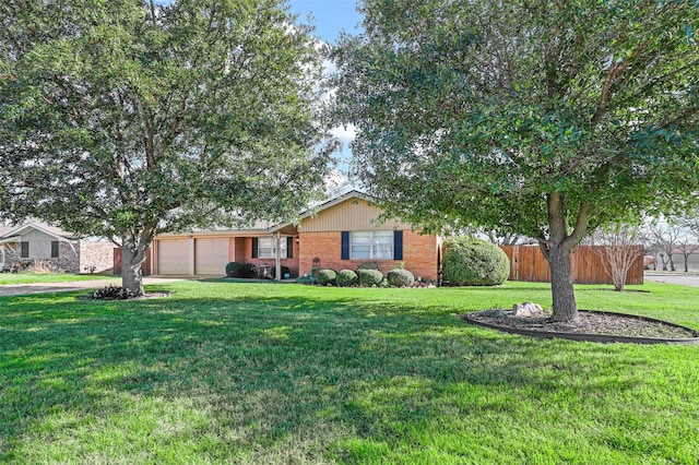 single story home with a front yard and a garage