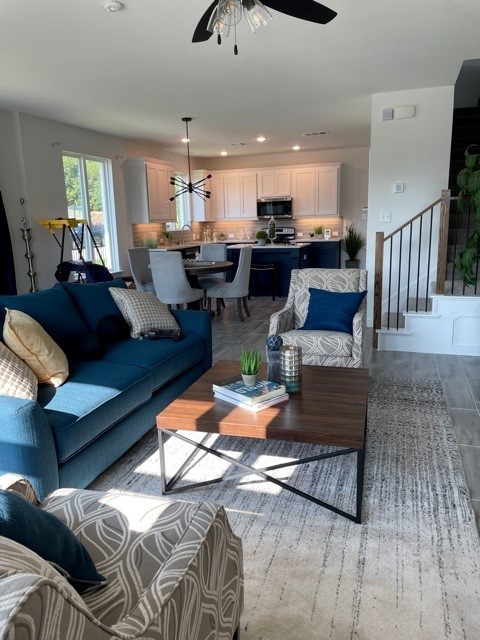 living room with hardwood / wood-style floors and ceiling fan