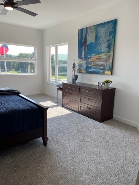 carpeted bedroom with ceiling fan