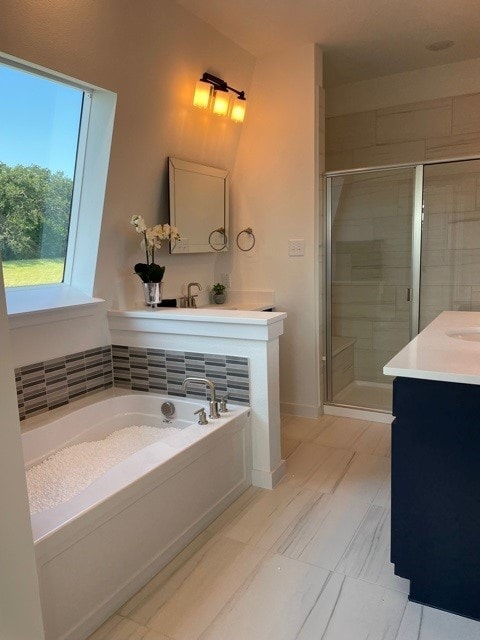 bathroom with separate shower and tub and vanity