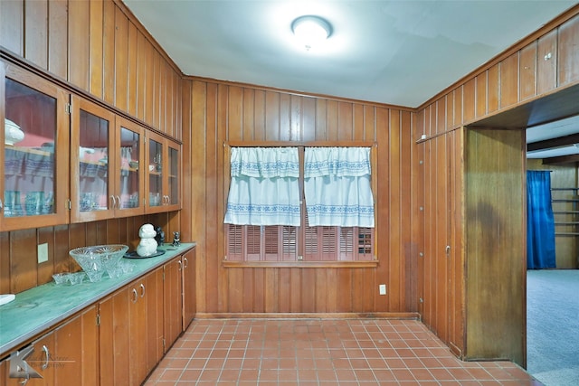 interior space featuring light carpet and wooden walls