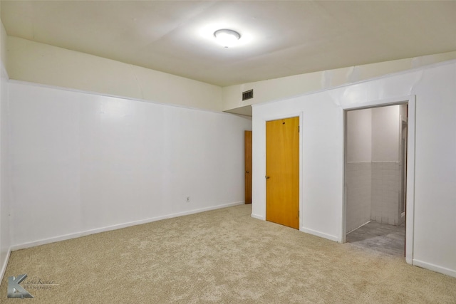 unfurnished bedroom featuring lofted ceiling, light carpet, and a closet