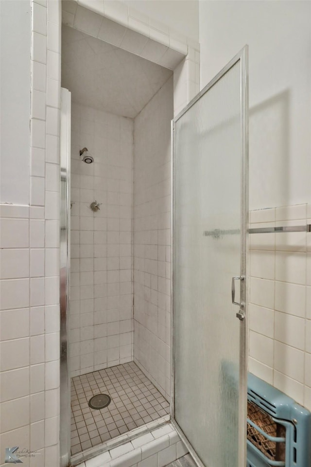 bathroom with walk in shower and heating unit