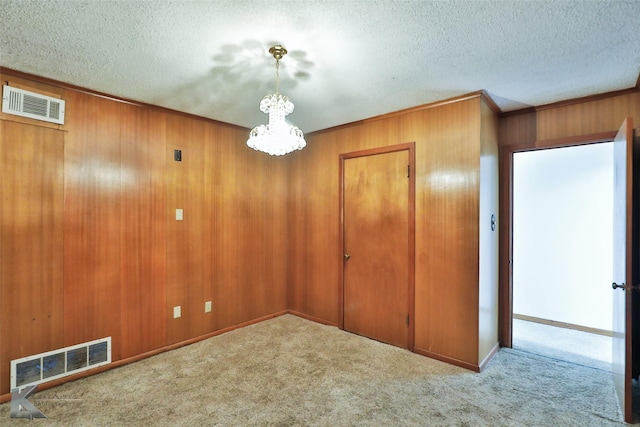 carpeted empty room with a textured ceiling