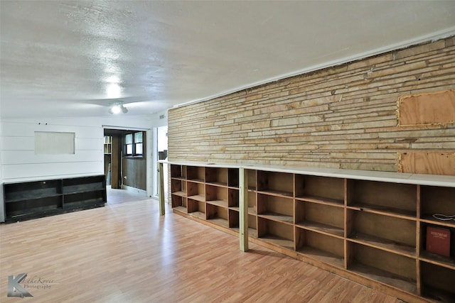 interior space featuring a textured ceiling and light wood-type flooring