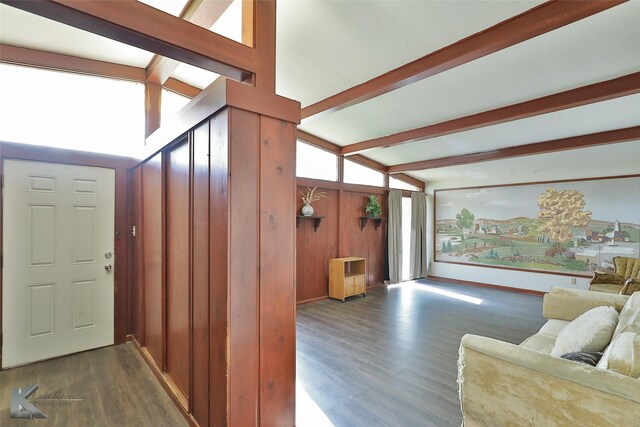 living room featuring vaulted ceiling with beams and dark hardwood / wood-style floors