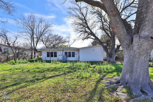 back of property with a yard and cooling unit