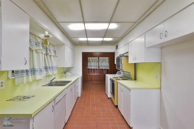 kitchen featuring sink, white cabinets, white appliances, and washer / dryer