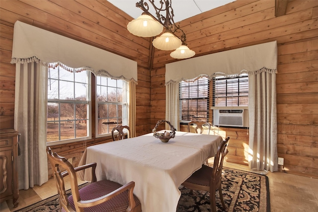 dining space with cooling unit and wooden walls