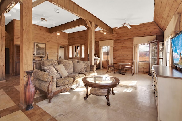 living room featuring light parquet floors, ceiling fan, and wood walls