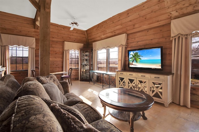 living room with ceiling fan, lofted ceiling, light wood-type flooring, and wooden walls