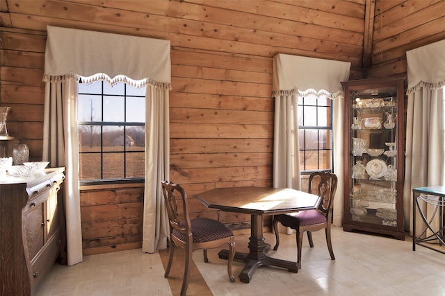 dining room featuring wooden walls