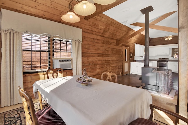 bedroom with cooling unit, wooden walls, and lofted ceiling with beams