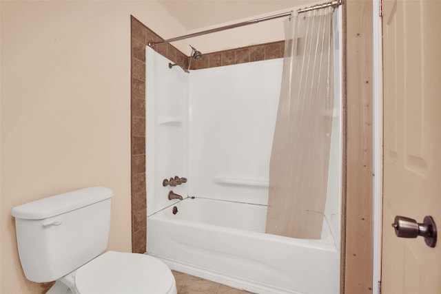 bathroom featuring toilet and tiled shower / bath combo