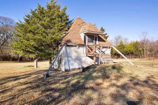 rear view of house featuring a yard