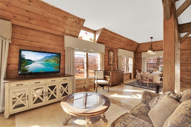 living room featuring vaulted ceiling, wooden walls, and light hardwood / wood-style floors