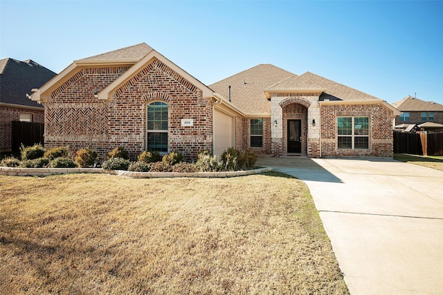 view of front of house with a garage and a front lawn