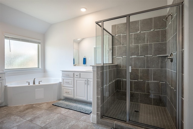 bathroom featuring vanity, lofted ceiling, and independent shower and bath