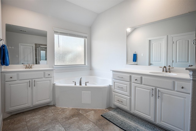 bathroom with plus walk in shower, vanity, and vaulted ceiling