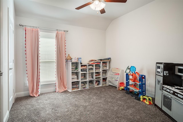 playroom featuring dark carpet, ceiling fan, and lofted ceiling