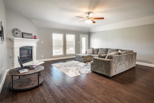 living room featuring ceiling fan and dark hardwood / wood-style floors