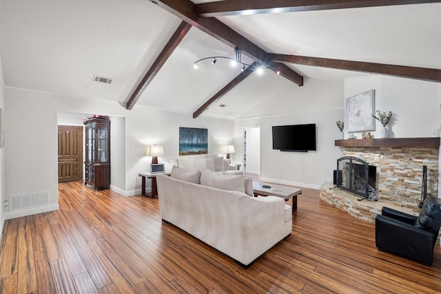 living room with hardwood / wood-style floors, lofted ceiling with beams, and a fireplace