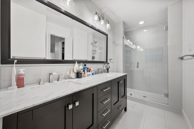 bathroom with tile patterned flooring, vanity, and a shower with door