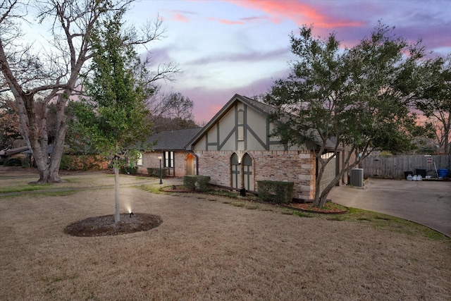 view of front of property featuring central AC and a garage