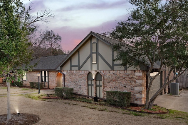 view of front of property featuring cooling unit and a garage