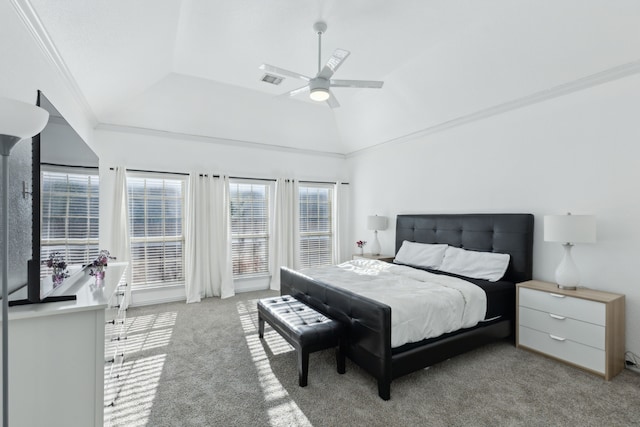 carpeted bedroom with a raised ceiling, vaulted ceiling, ceiling fan, and ornamental molding