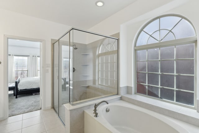 bathroom featuring tile patterned flooring and shower with separate bathtub