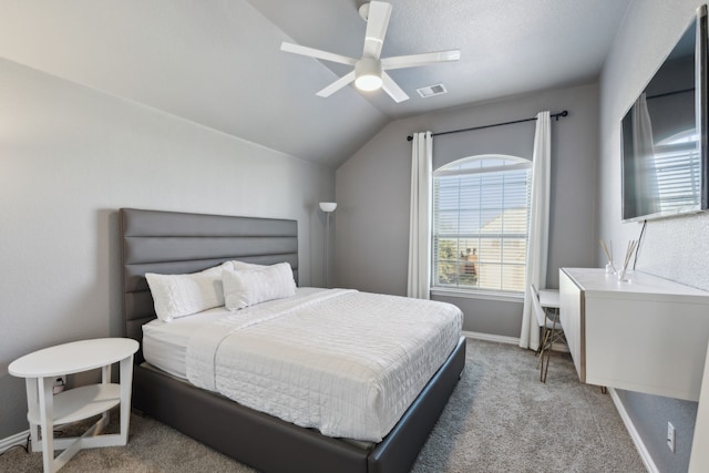 carpeted bedroom featuring ceiling fan and vaulted ceiling