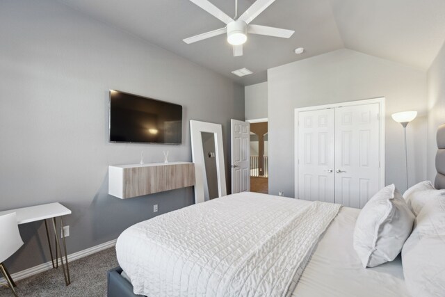 bedroom with ceiling fan, a closet, carpet, and lofted ceiling