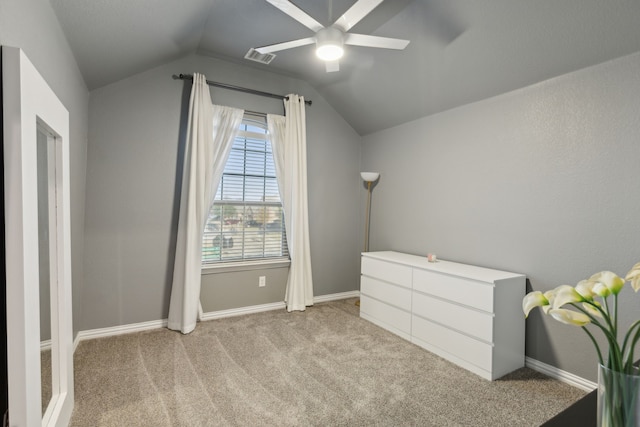 unfurnished bedroom with light carpet, vaulted ceiling, and ceiling fan