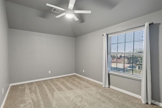 unfurnished room featuring ceiling fan, light colored carpet, and vaulted ceiling