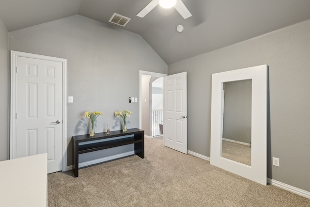 carpeted bedroom with ceiling fan and vaulted ceiling