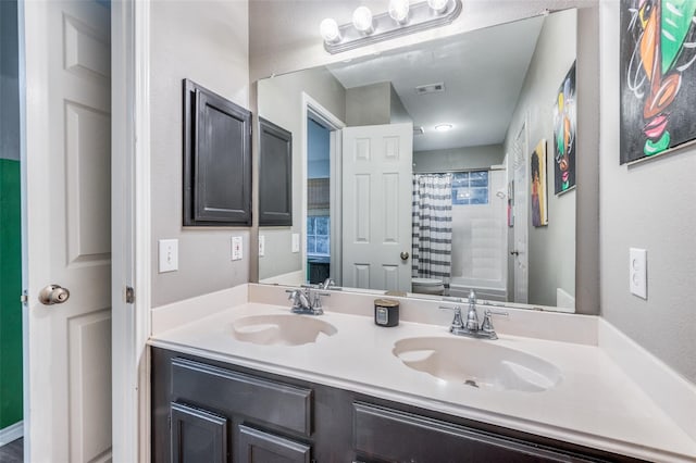 full bathroom with vanity, shower / bath combination with curtain, and toilet