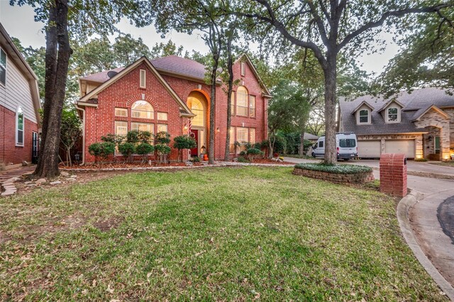 view of front of property with a front yard and a garage