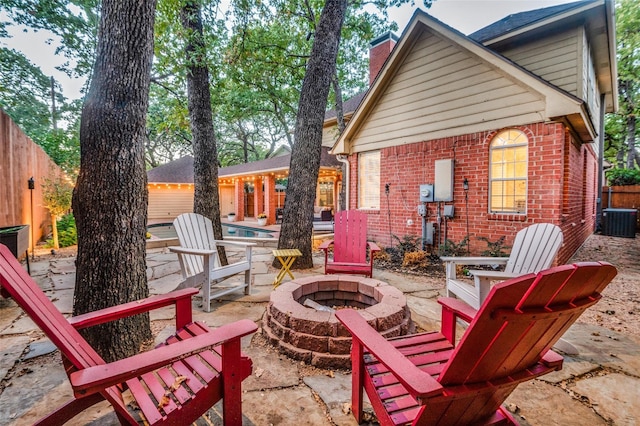 view of patio / terrace with cooling unit and an outdoor fire pit